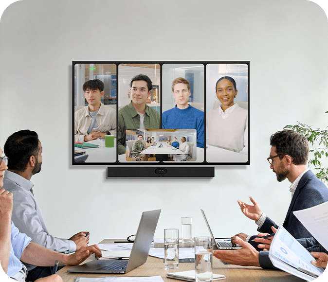 Contemporary boardroom featuring dual screens, integrated video conferencing bar, and clean commercial AV design