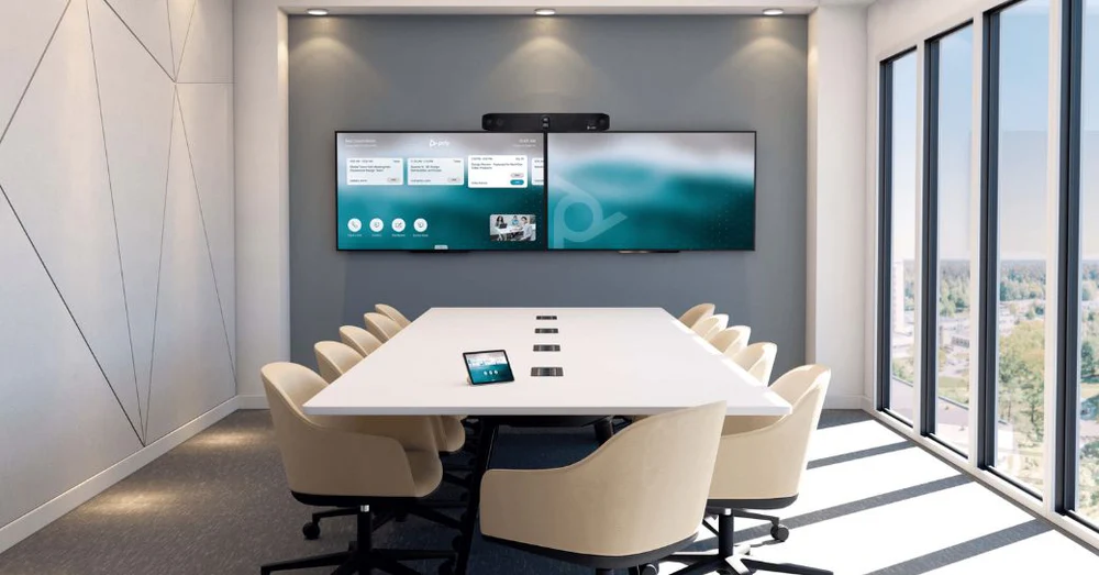 Modern corporate conference room with dual wall-mounted displays, professional video conferencing system, and integrated AV setup